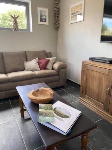 a living room with a table with a hat on it at Valgrange in Tenneville