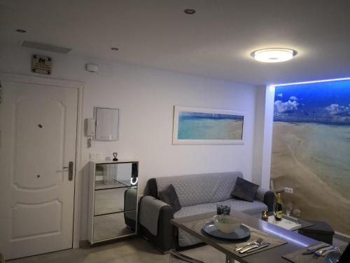 a living room with a couch and a table at Blue Horizon Luxury Apartment in Nerja