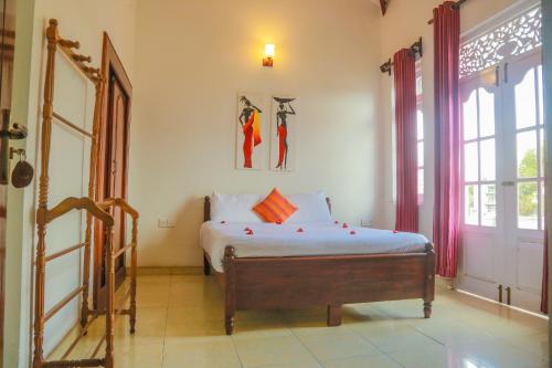a bedroom with a bed and a window and a door at Inroma Holiday Resort in Nuwara Eliya