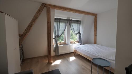 a bedroom with a bed and a window at Joyful Apartments Sopot in Sopot