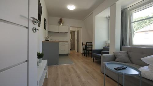 a living room with a couch and a table at Joyful Apartments Sopot in Sopot