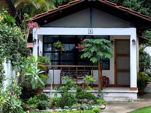 a small house with a bench in the garden at Villas JABEL TINAMIT in Panajachel
