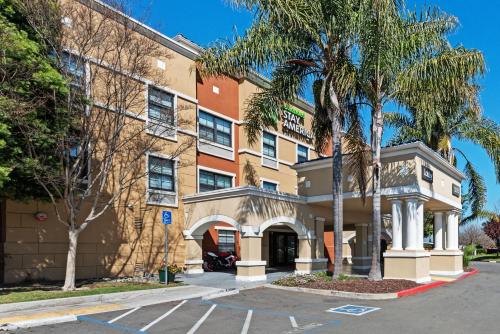 a building with a palm tree in front of it at Extended Stay America Suites - Fremont - Newark in Fremont