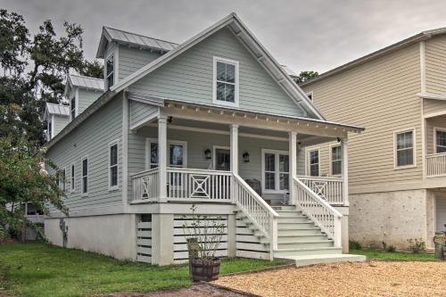 a house with a porch and stairs in front of it at Modern and Spacious St Simons Home 4 Mi to Beach! in Ebo Landing