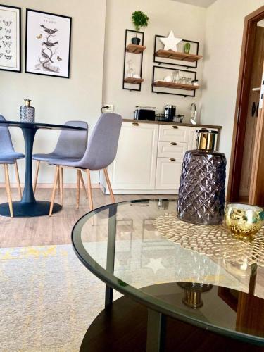 a living room with a glass table and chairs at Bali Butique Rooms in Nyergesújfalu