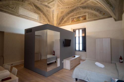a bedroom with a ceiling with a mirror and a bed at Le Residenze di Mantova in Mantova