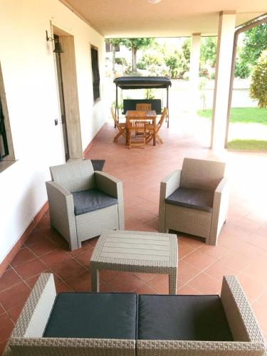 a patio with chairs and a table and a gazebo at casa TRE19 in Mantova