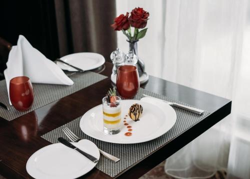 a table with a white plate with a dessert on it at Crowne Plaza Nairobi Airport by IHG in Nairobi