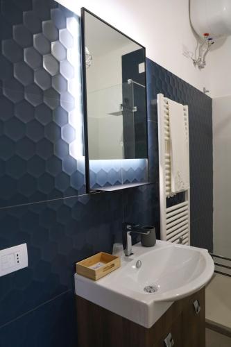 a bathroom with a white sink and a mirror at Agriturismo Cantina Morone in Guardia Sanframondi