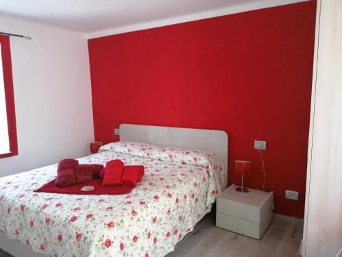 a red bedroom with a bed with red walls at Casa vacanza la Rosa in Vinadio