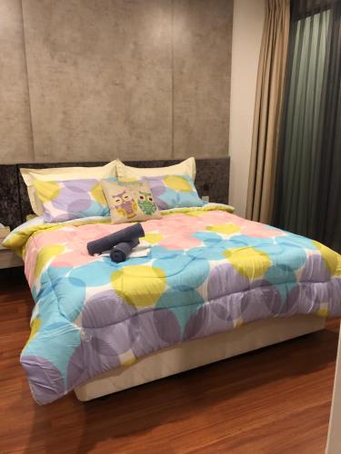 a bed with a stuffed animal on top of it at Sun-Suite in Shah Alam