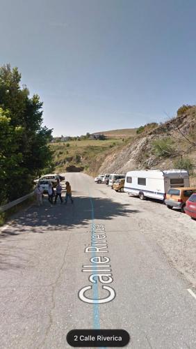 a group of people walking down a road at La Hoja de Roble in Puebla de Sanabria