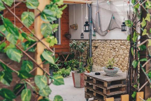 a patio with a wooden table and some plants at Siglas & Runas II in Póvoa de Varzim