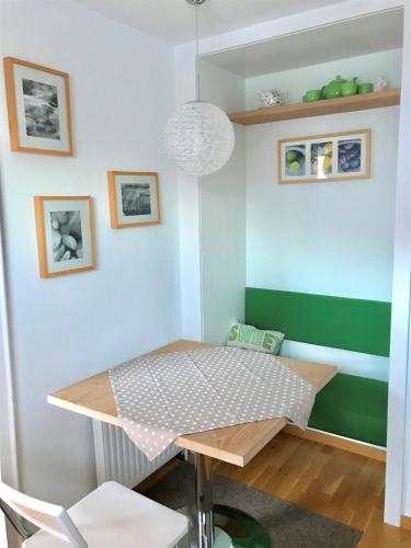 a table in a room with a green and white wall at Ferienwohnung Lechner Traudi Kreuzschied 141 in Neukirchen am Großvenediger