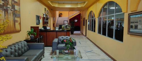 a waiting room with a couch and a table at Hotel San Miguel in Morelia