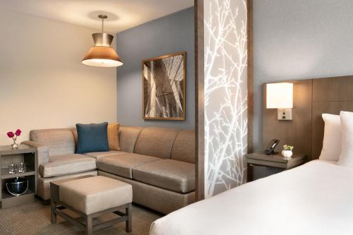 a hotel room with a couch and a bed at Hyatt Place Fort Lee/George Washington Bridge in Fort Lee