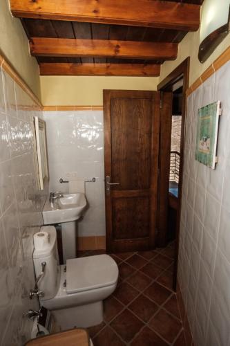 a bathroom with a toilet and a sink at HOUSES RENTAL The BEST VIEWS in Tejeda