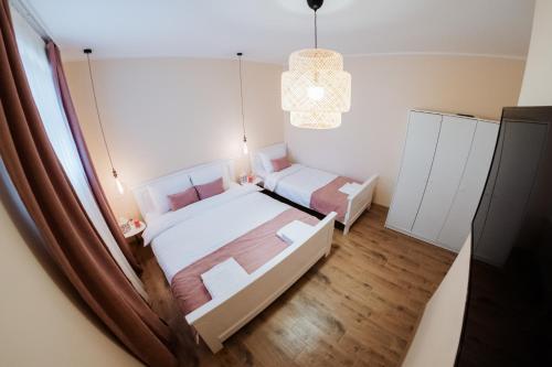 Ένα ή περισσότερα κρεβάτια σε δωμάτιο στο Apartman Cute&Cosy Lux