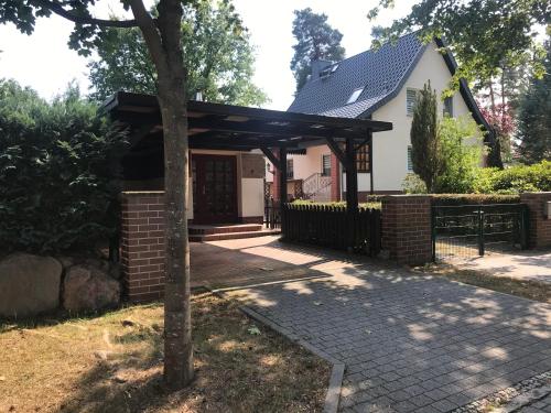 a house with a pavilion in front of it at Ferienhaus an den Moorwiesen in Bad Saarow