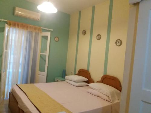a bedroom with a bed with two pillows on it at Irene's studios in Panormos Kalymnos