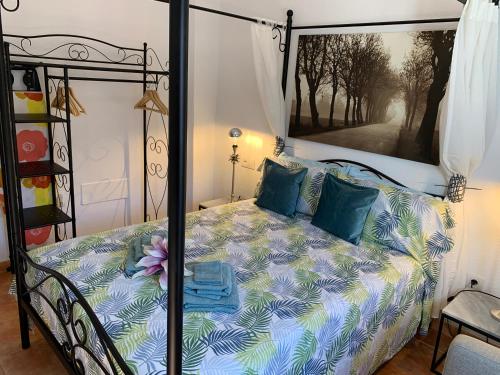 a bedroom with a bed with blue and green pillows at Dream Ravine in Santa Cruz de Tenerife