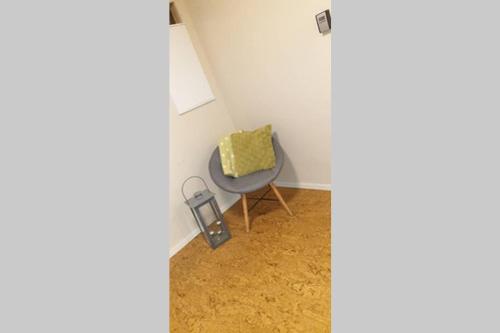 a small room with a chair with a yellow pillow at Dalen Studio 1 in Dalen