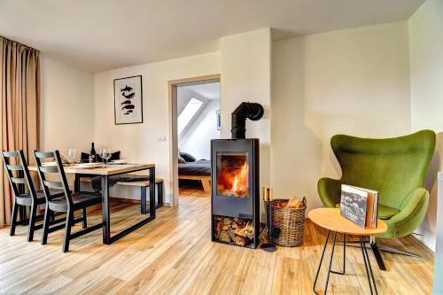 a living room with a fireplace and a table and chairs at Dvě Zátoky Kovářov in Kovářov