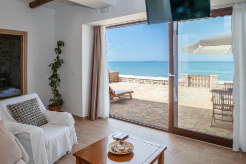 a living room with a view of the ocean at Abraham Apartments in Acharavi