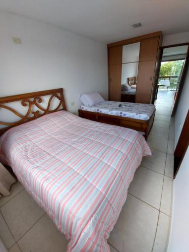 apartamento em serra negra - bezerros في بيزيروس: غرفة نوم صغيرة مع سرير ومرآة