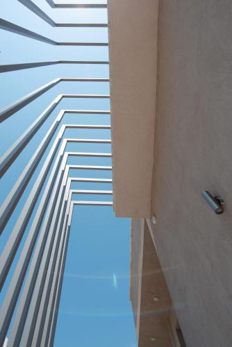 a bathroom with a view of a wall with lines at SunBlue Boutique Villas in Skala Rachoniou