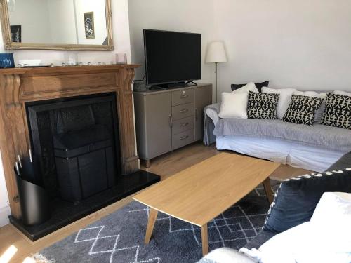 a living room with a couch and a fireplace at Sonas Luxury Living in Dungarvan