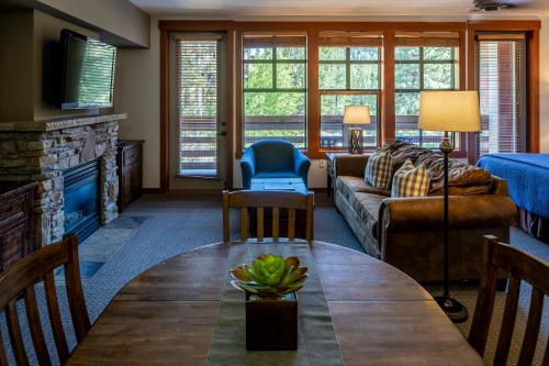a living room with a couch and a table at The Village Lodge in Mammoth Lakes