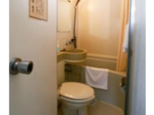 a small bathroom with a toilet and a sink at Business Hotel Heisei - Vacation STAY 90551 in Yonezawa