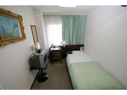 a hotel room with two beds and a television at Business Hotel Heisei - Vacation STAY 90548 in Yonezawa