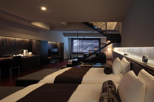 a hotel room with two beds and a staircase at Bourou Noguchi Hakodate in Hakodate