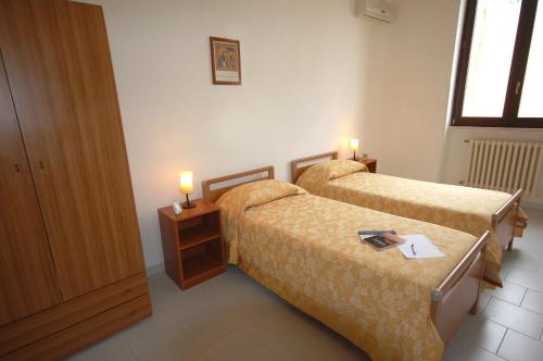 a hotel room with two beds and a window at Albergo Del Santuario in Leuca