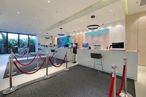 a room with red ropes and a counter in a building at Haikou Meilan International Airport Hotel in Haikou