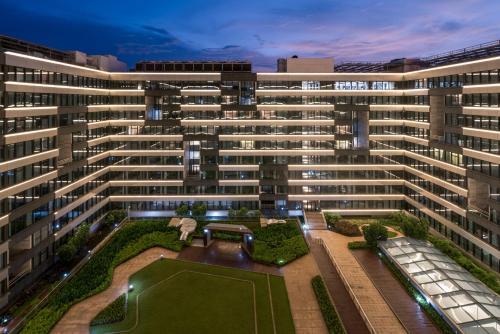 eine Luftansicht auf ein großes Gebäude mit Garten in der Unterkunft Haikou Meilan International Airport Hotel in Haikou