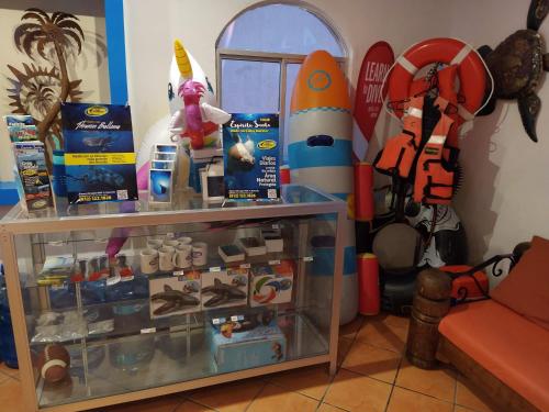 a room with a shelf with toys in it at Club Cantamar Beach Hotel & Marina in La Paz