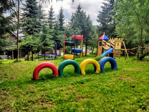 a playground with colorful signs in the grass at Rezidence Kouty in Loučná nad Desnou