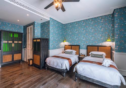 Postel nebo postele na pokoji v ubytování Guangzhou Nansha Stone Inn