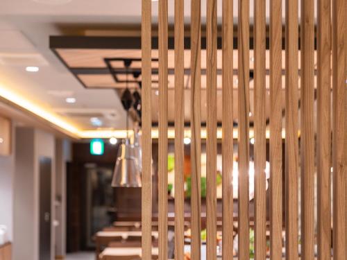 a staircase in a building with wooden walls at Super Hotel Sendai Airport Inter in Natori