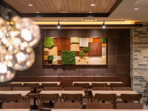 a dining room with tables and chairs at Super Hotel Sendai Airport Inter in Natori