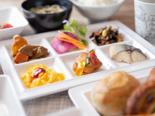 a plate of different types of food on a table at Super Hotel Sendai Airport Inter in Natori
