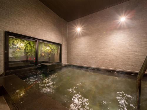 a room with a pool of water in the floor at Super Hotel Sendai Airport Inter in Natori