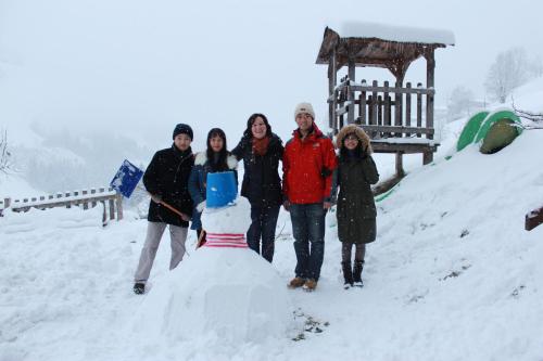 a group of people standing next to a snowman at Schaidreithof in Grossarl