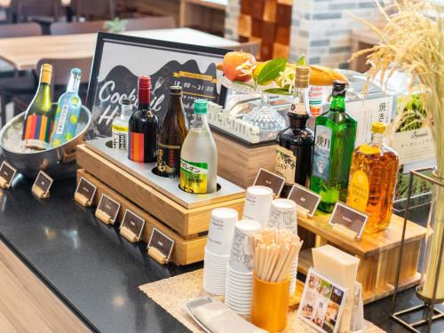 a bar with bottles of alcohol on a table at Super Hotel Sendai Airport Inter in Natori