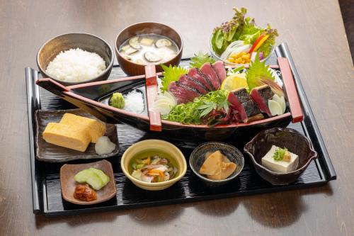 a tray with different types of food on a table at JR Clement Inn Kochi in Kochi