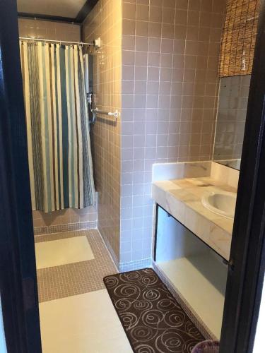 a bathroom with a sink and a shower at Kerteh Apartment in Kertih