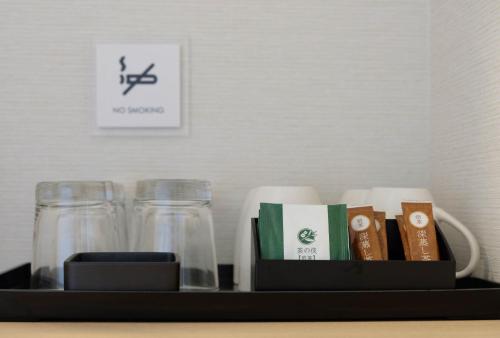 a shelf with two mason jars and a box at The Light Inn Tokyo in Tokyo
